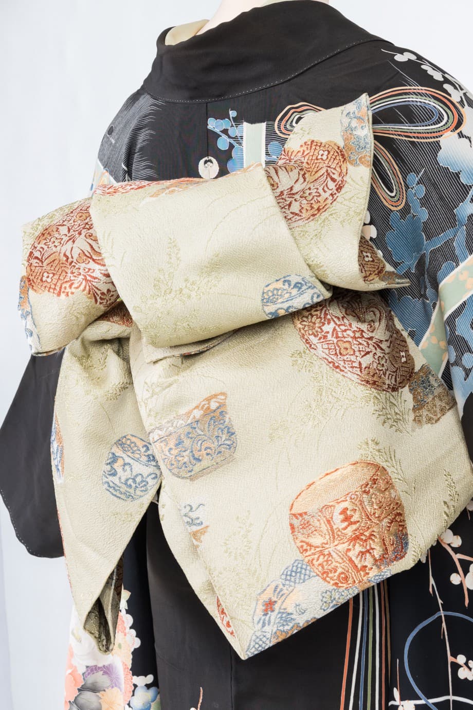 【和装の結婚式】渋めの色合いで花薬玉が描かれた黒振袖